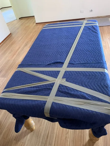 Large appliance protected in moving blanket